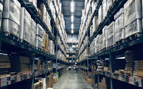 Copper Ridge Cartridge Co. warehouse aisle with pallet racking and shipping boxes.