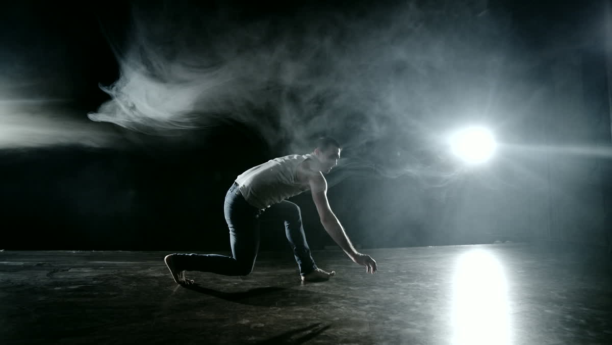 Frame from the motion study: the dancer loads into a crouch before the launch.