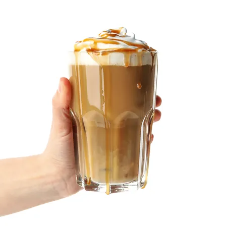 A hand holding a tall layered iced latte.