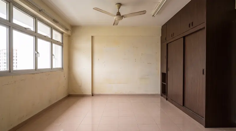 Before: the same bedroom with beige tiles, a brown sliding-door wardrobe and a fluorescent tube.