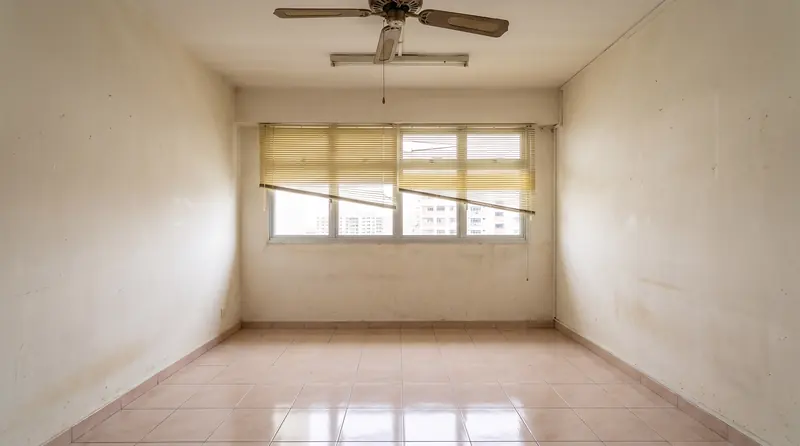 Before: the same room empty, with beige tiles, a broken blind and a fluorescent tube.
