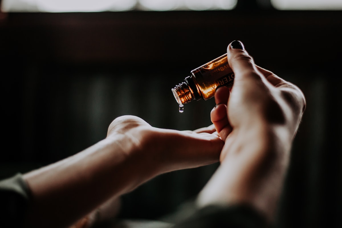 Hands applying cream during a calm facial treatment.