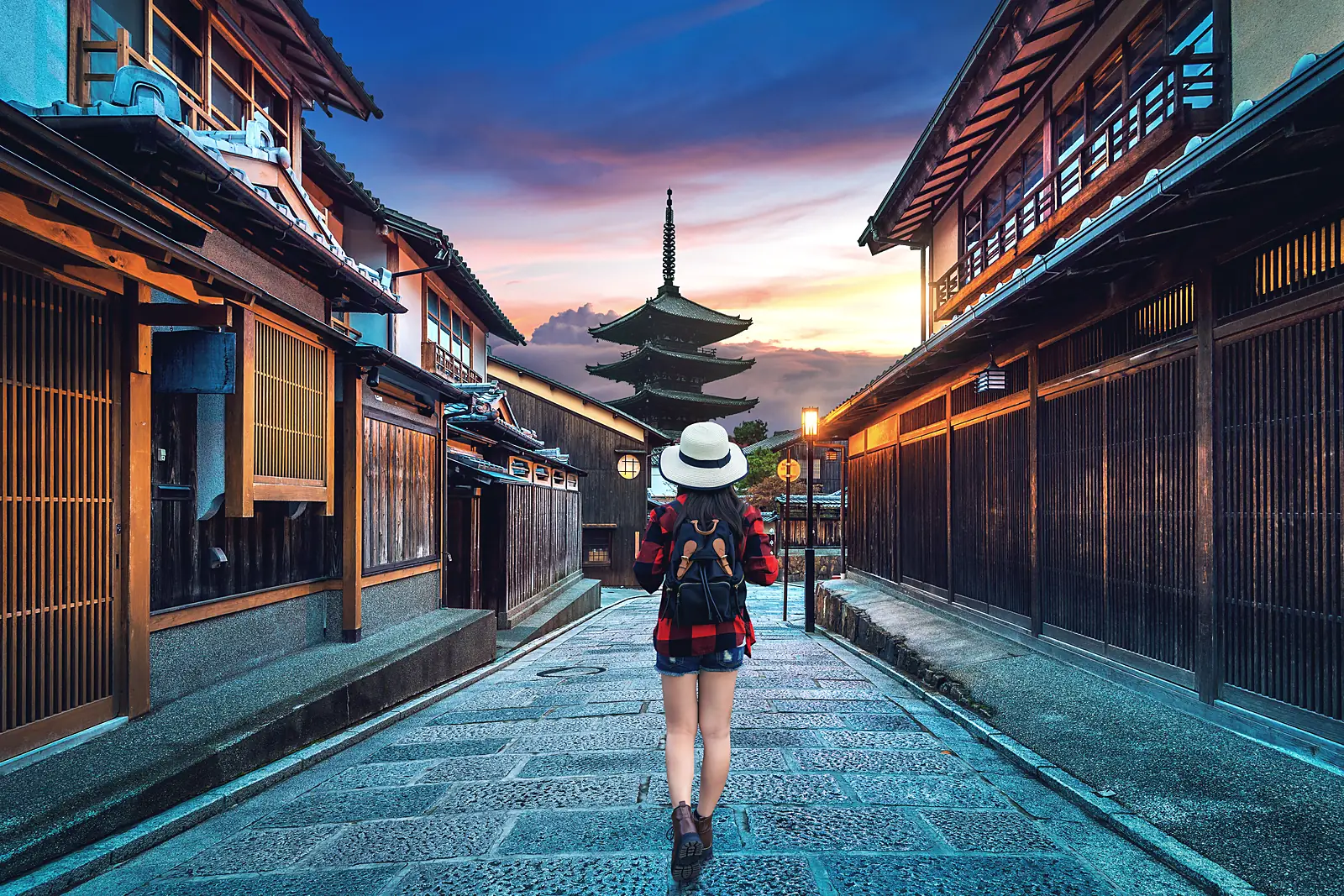 A traveller walking the Ninenzaka lane toward Yasaka Pagoda at dawn